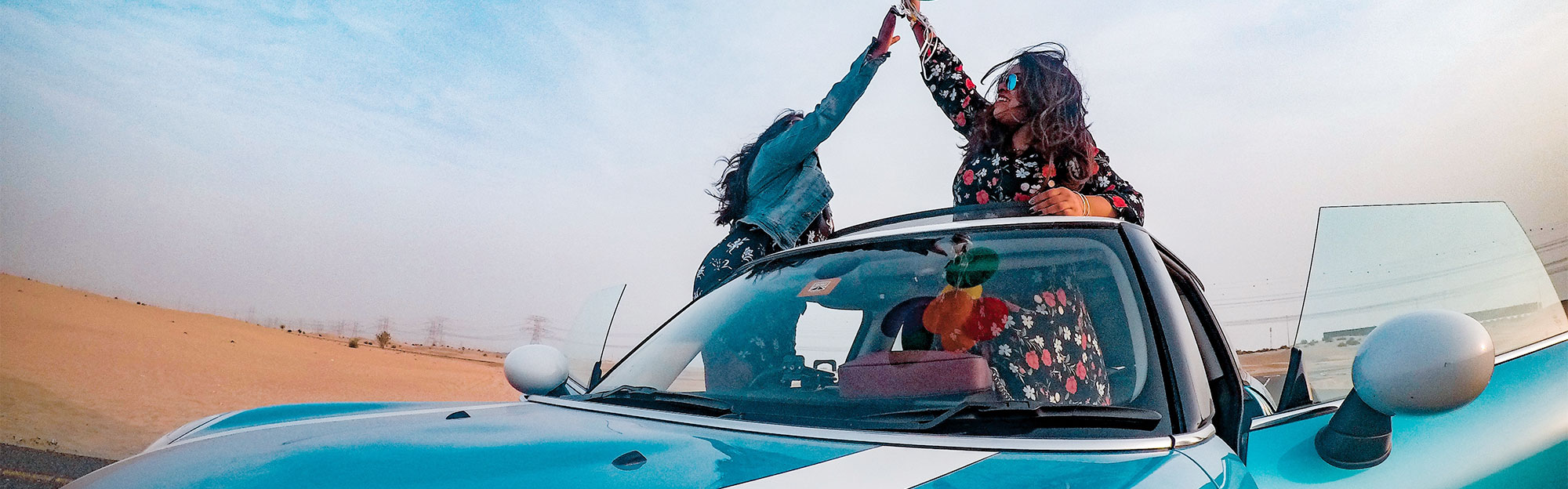Consumer Loan Origination - Women in blue car with balloons