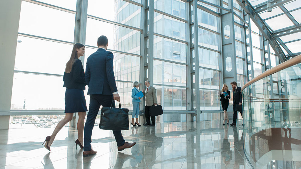 people walking through an office