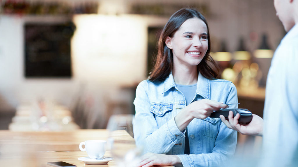 Woman paying for coffee