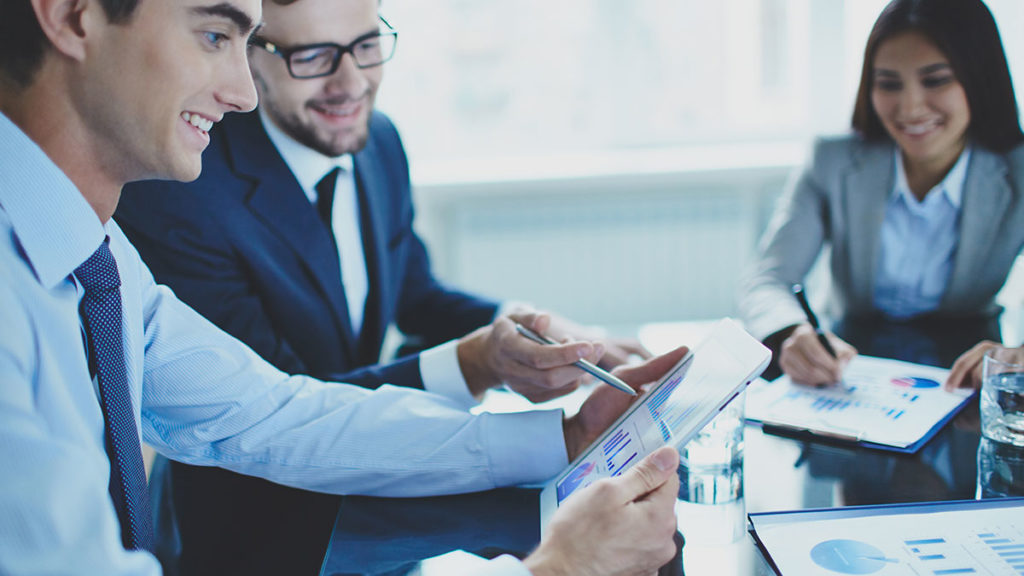 two men looking at financial results