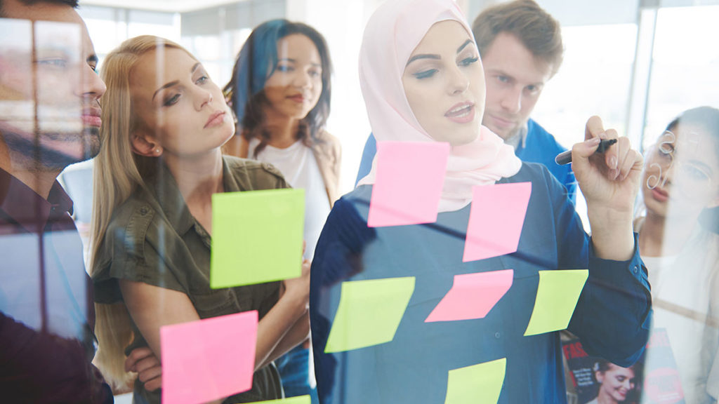 Muslim business woman discussing plans with co-workers