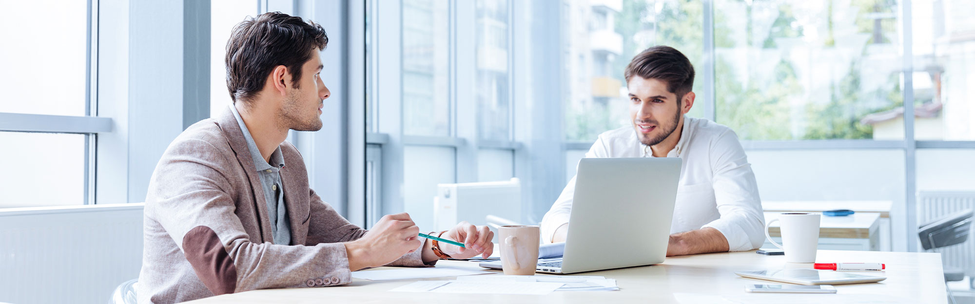 Temenos Value Benchmark Program - 2 office workers in a conference room