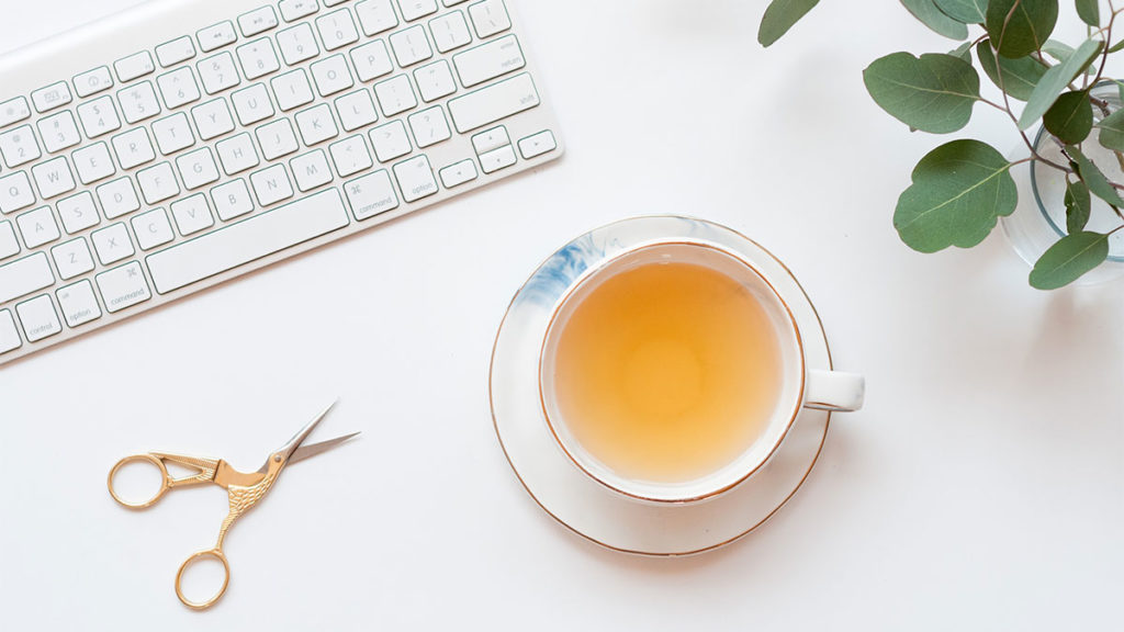 Small Business - Keyboard and a pair of scissors on a desk