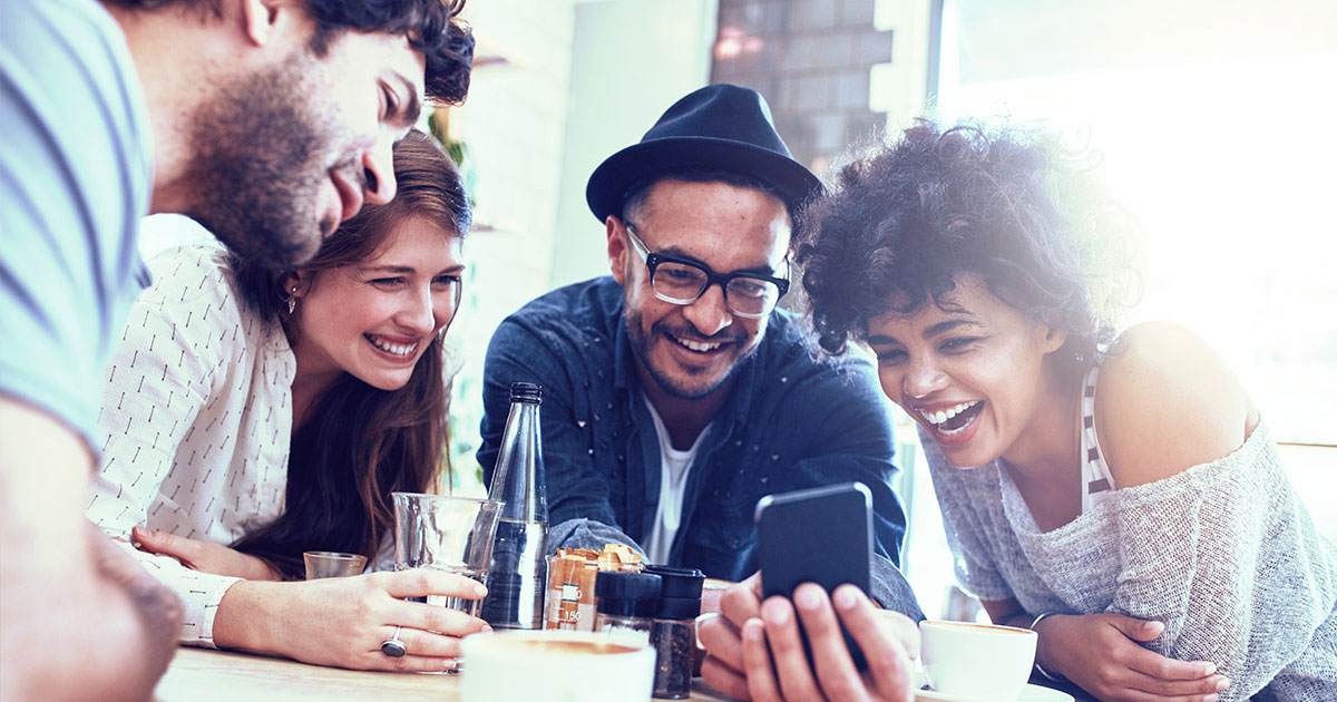 Temenos Infinity - Happy people looking at a phone