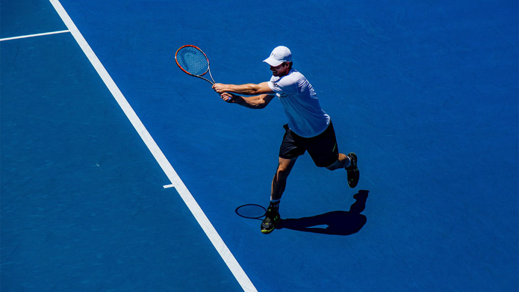 Regulatory Compliance - Tennis player on blue court
