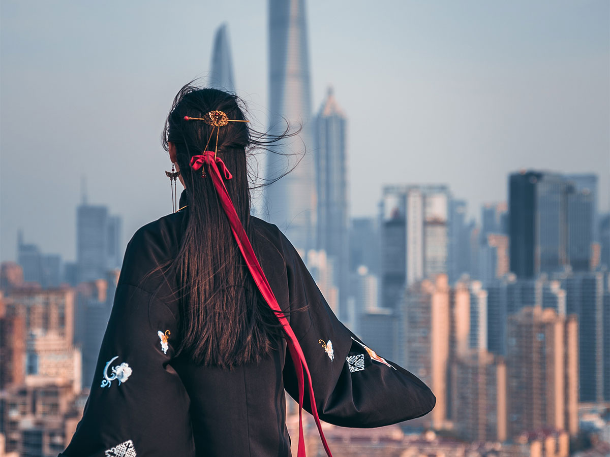 Regulatory Compliance - Chinese woman looking at city