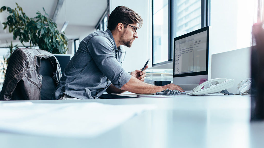 Temenos Security - Software Developer working on computer at desk