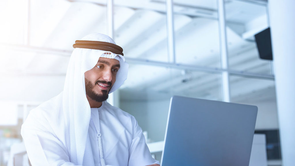 Temenos SaaS - Middle Eastern man working at laptop