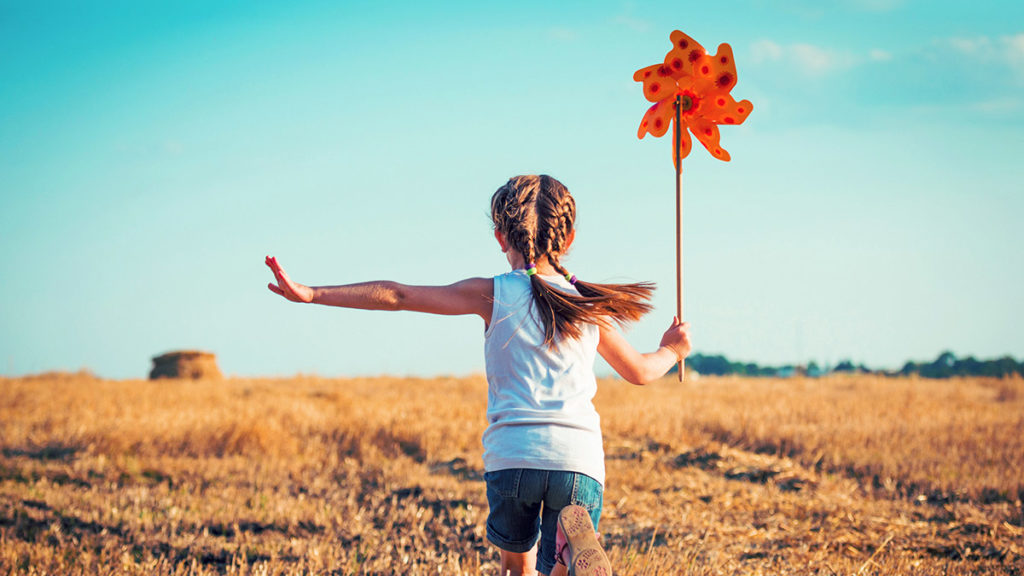 Running through field with toy
