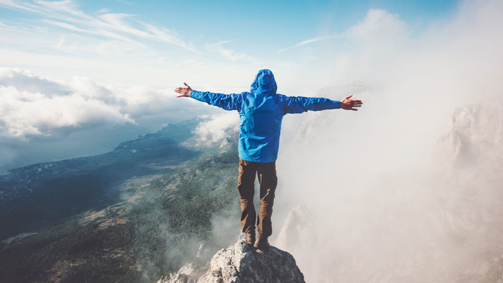 Temenos SaaS - Man standing atop mountain
