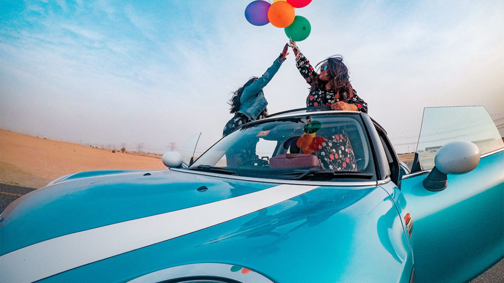 Consumer Loan Origination - Women in blue car with balloons