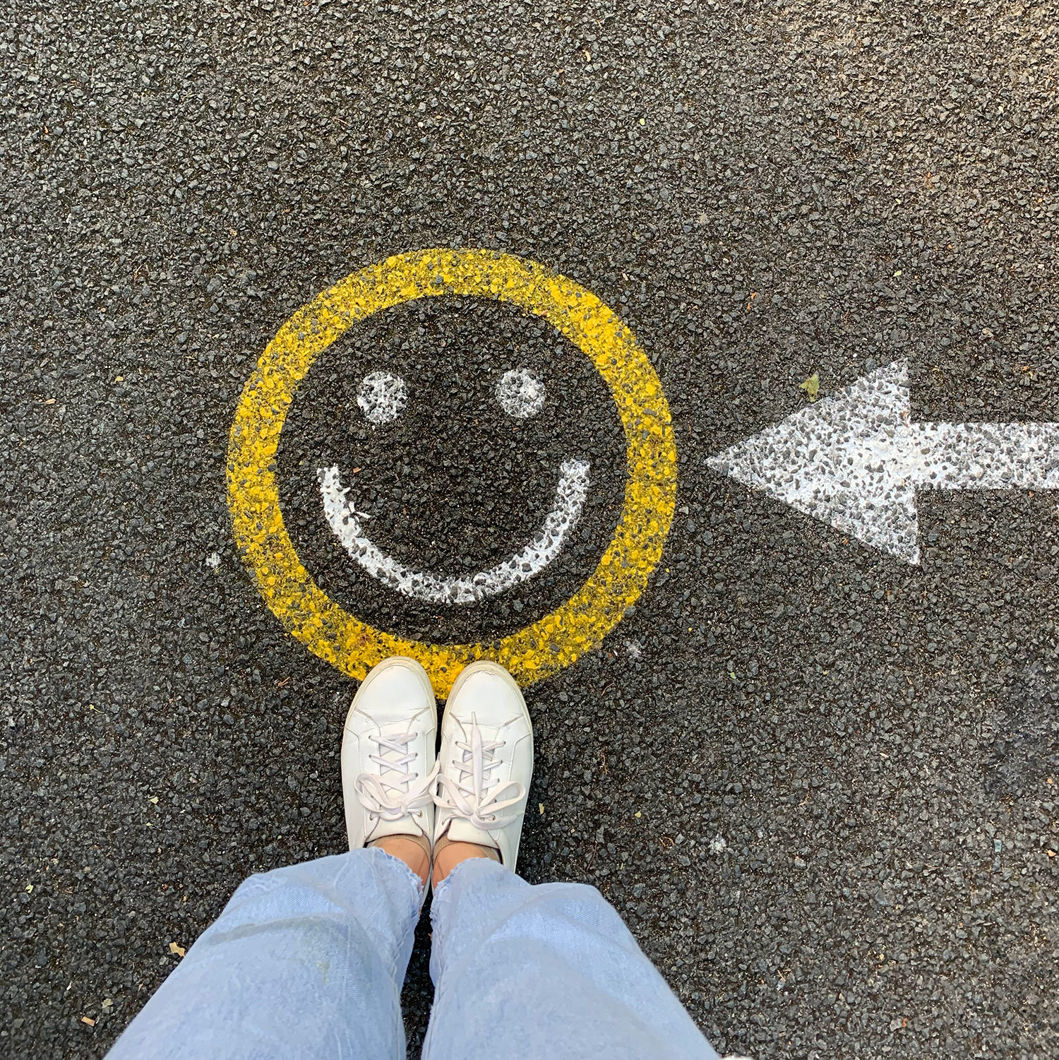 A smiley face on the pavement.
